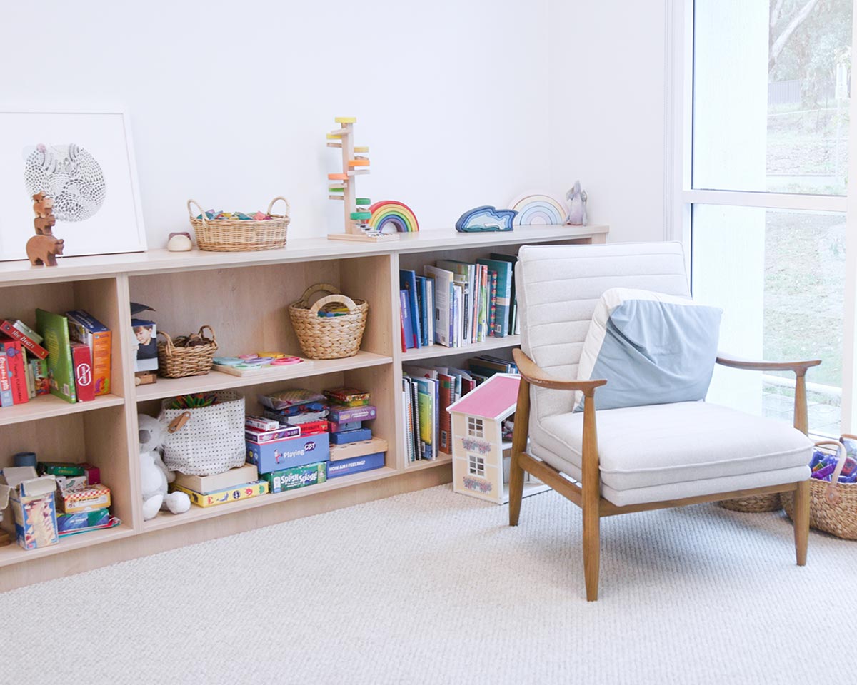 Comfortable child-friendly therapy room at HeartSoundMind Consulting with books, toys and a welcoming counselling chair.